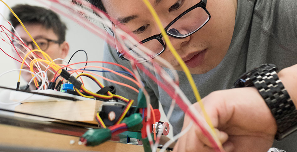 student working on computer circuits student working on computer circuits