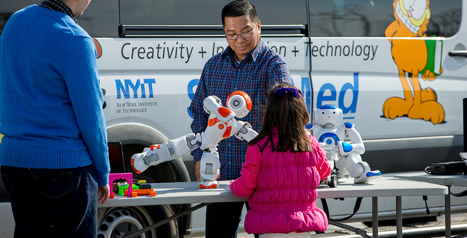 Child and instructor work with robot Child and instructor work with robot