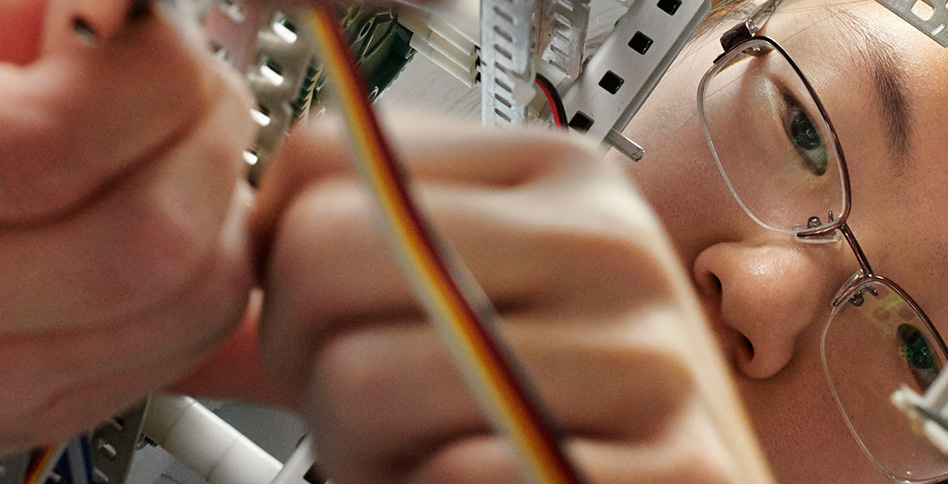 Closeup of student working on circuits Closeup of student working on circuits