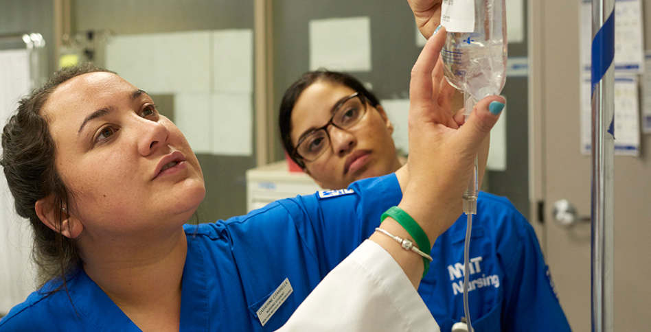 Students and instructor looking at IV Students and instructor looking at IV