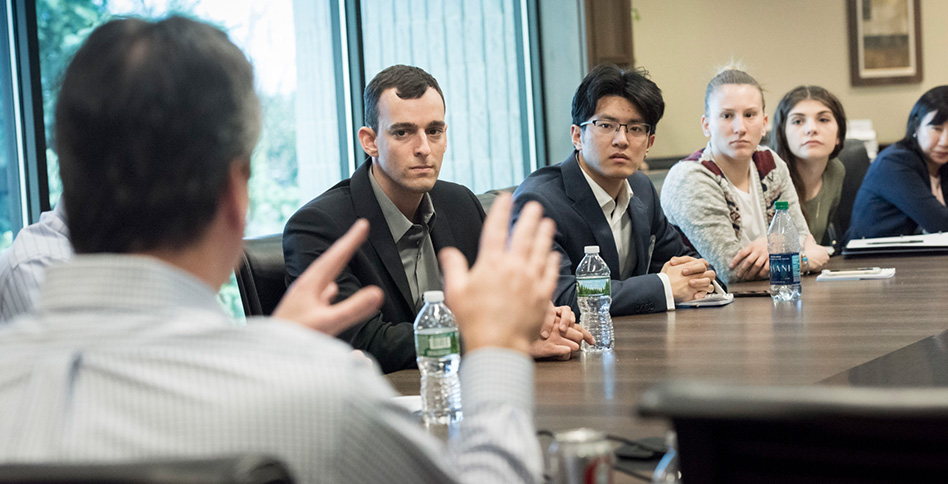 Students discuss around table Students discuss around table