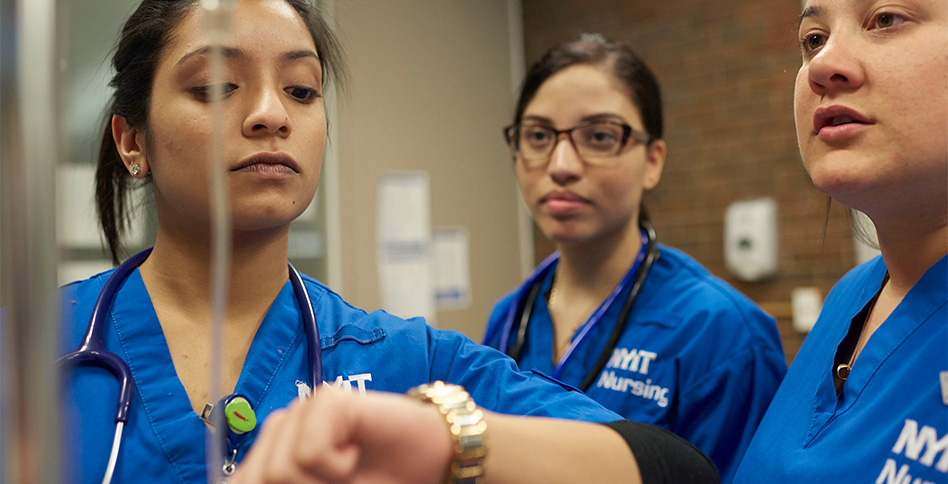 Students and instructor looking at IV Students and instructor looking at IV