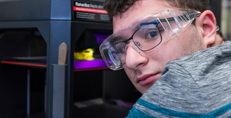 Student using 3D printer Student using 3D printer