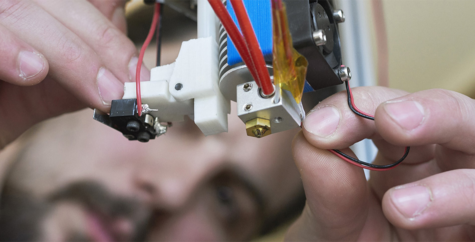 Student working on machine wiring