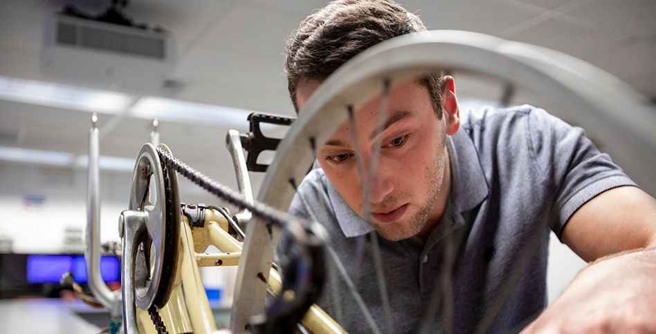 Student working on automated bicycle
