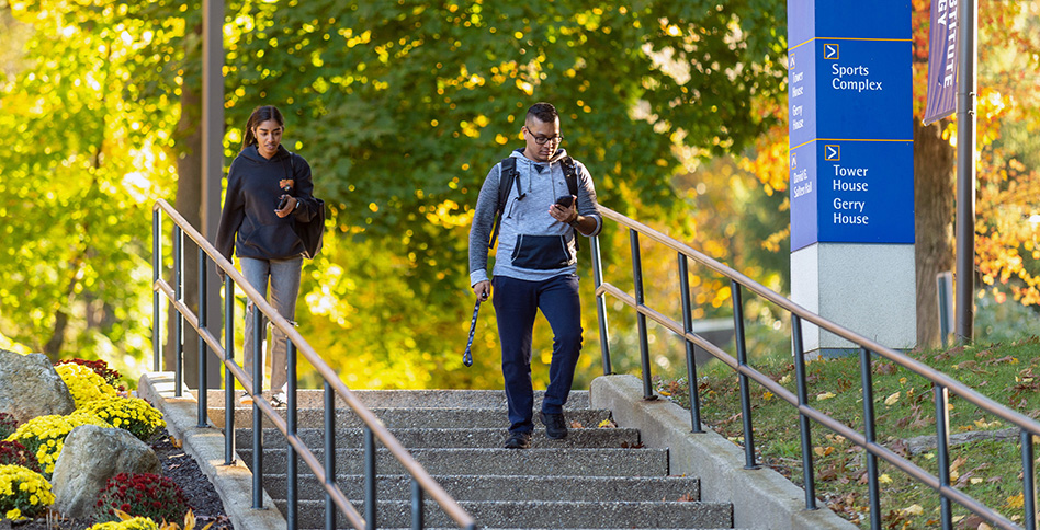 Two people walking down outside stairs Two people walking down outside stairs
