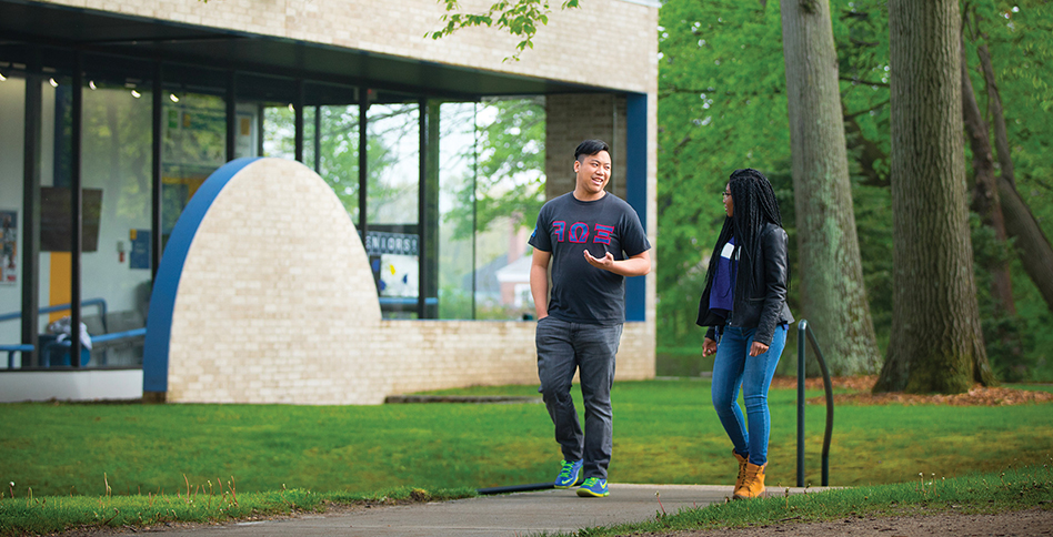 Two students walking in front of Long Island campus building