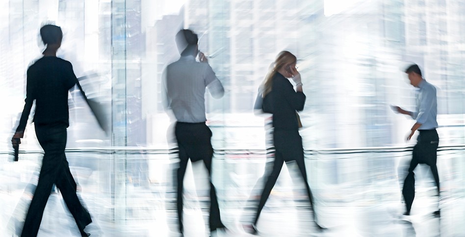 Business people walking in glass atrium