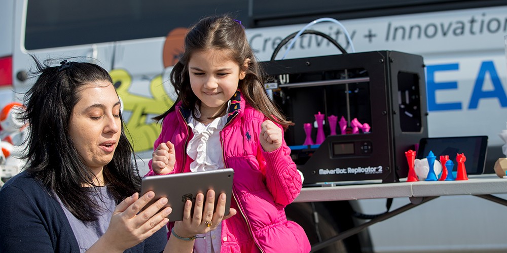 Teacher and child looking at tablet.