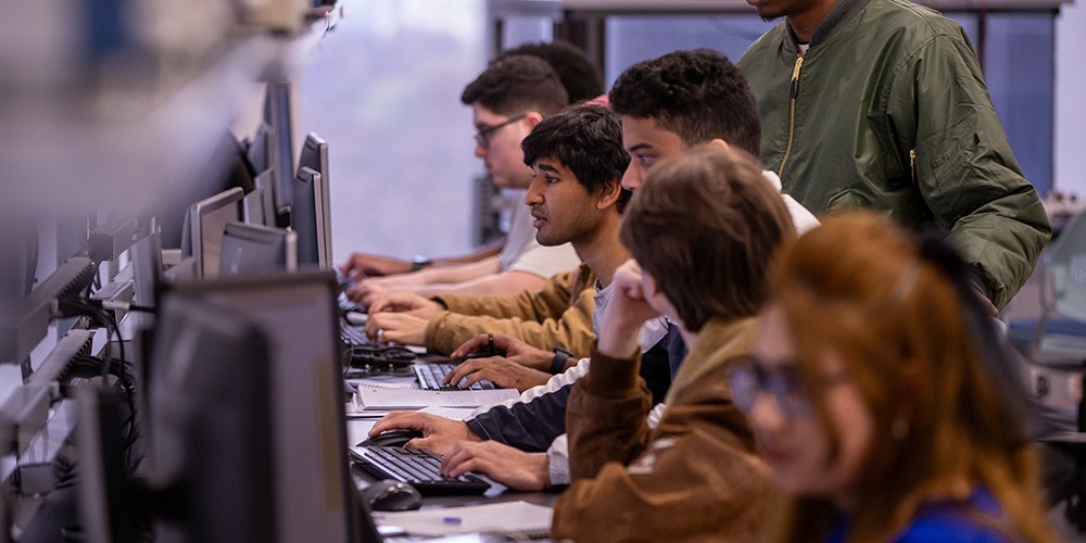 Many students working on computers at the same time.