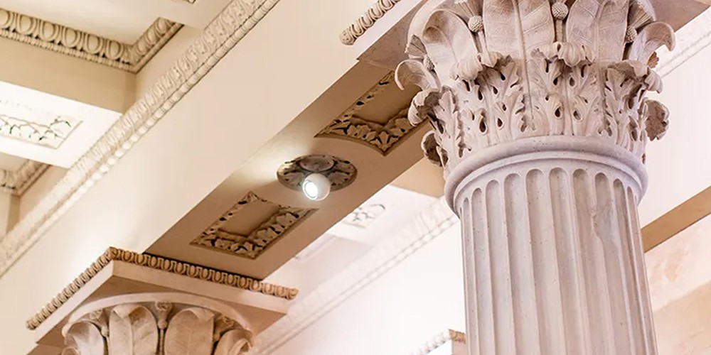 Lighting fixture in ornate ceiling.