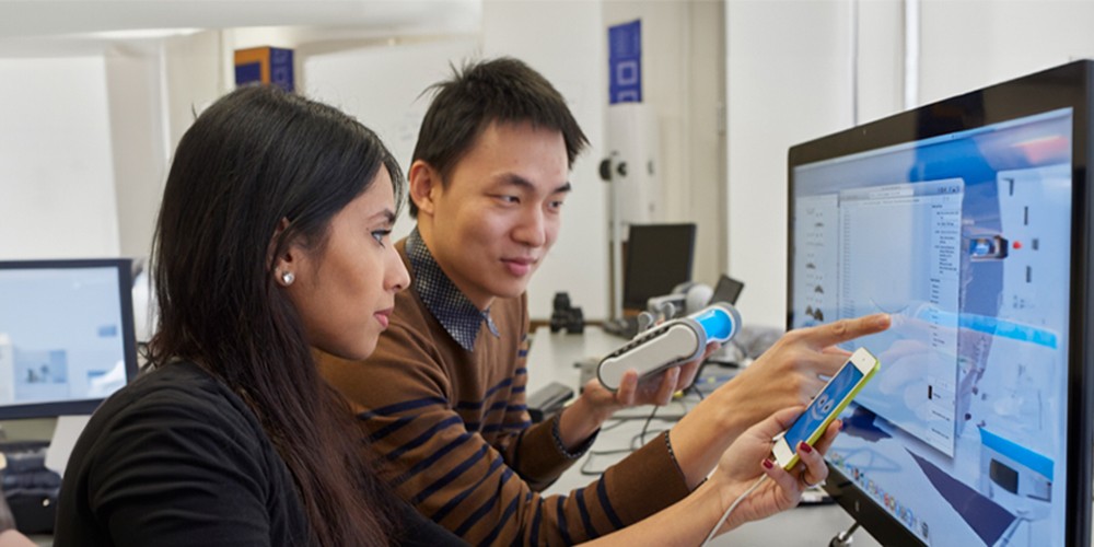 Students working in lab with devices.