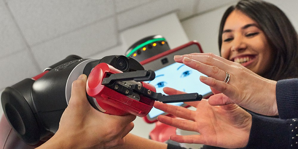 Students playing with robot