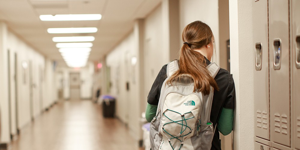 Student leaning against lockers
