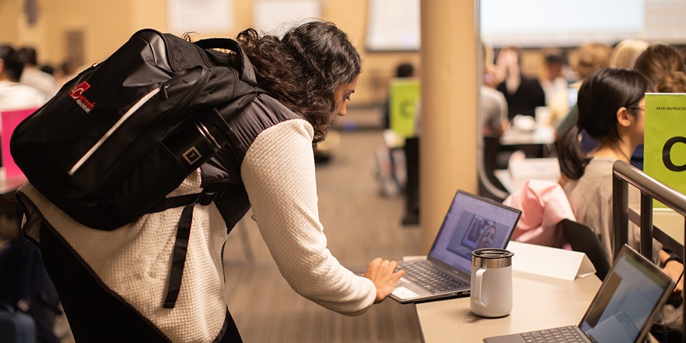 Woman looking at video meeting on laptop