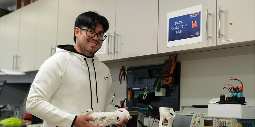 Student holding 2D model