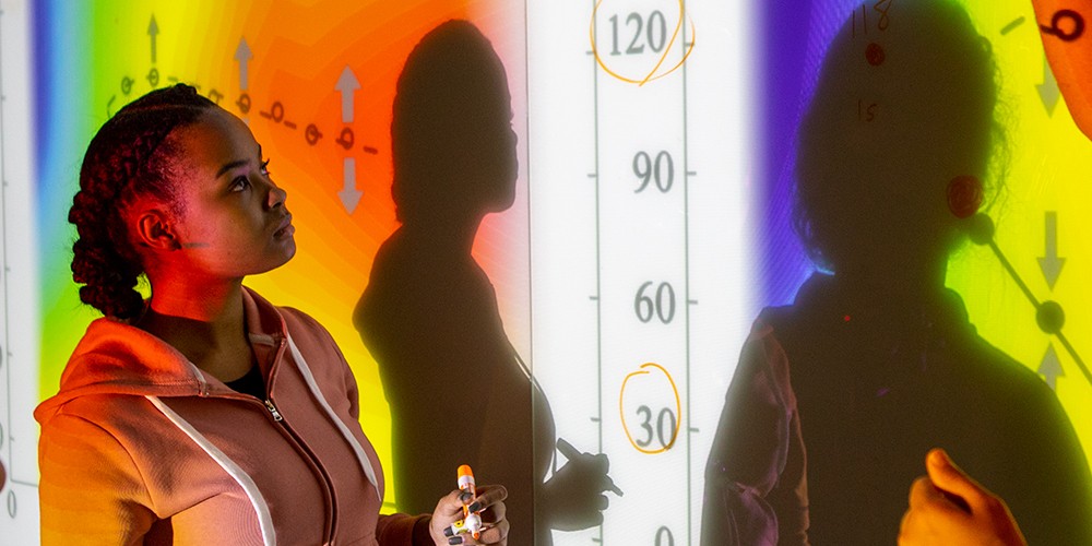 Girl in front of projected graph