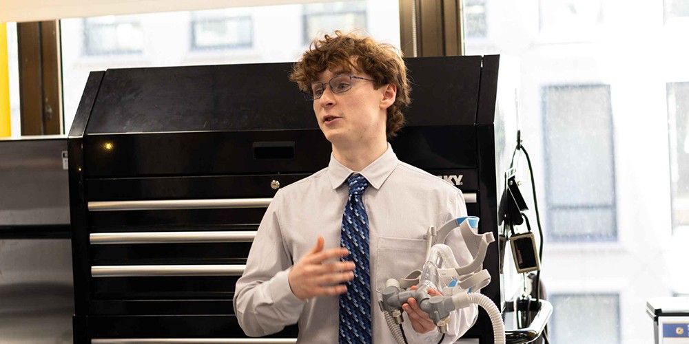 Student holding 3D model