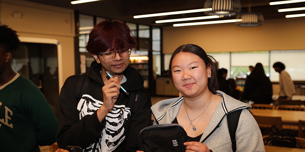 Two students smiling