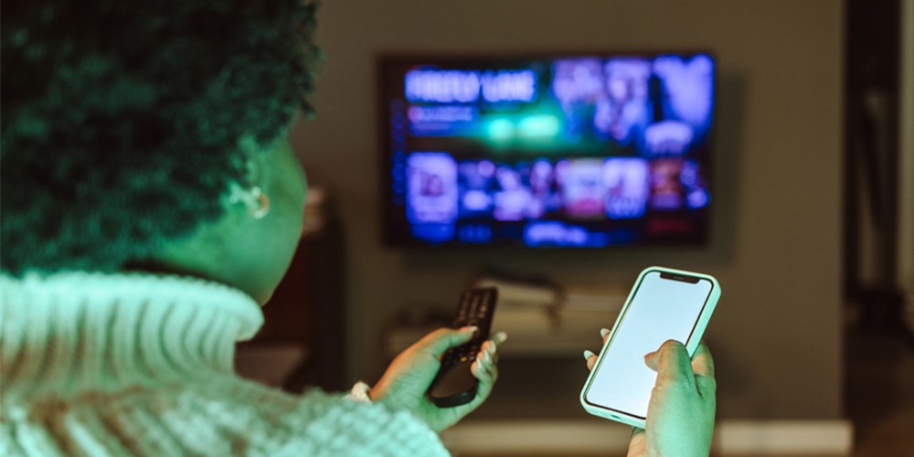 Woman using TV remote