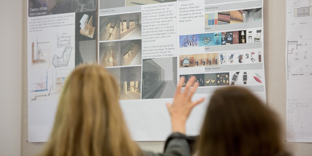 People looking at design board