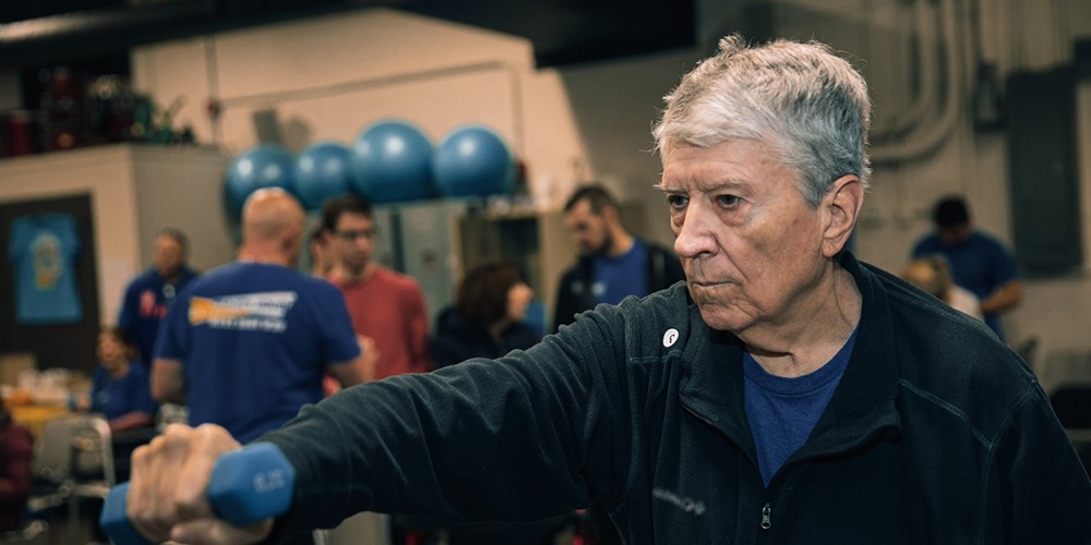 Man using barbells to exercise
