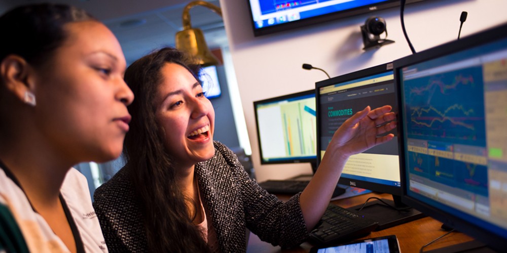Two women talking about computer screen